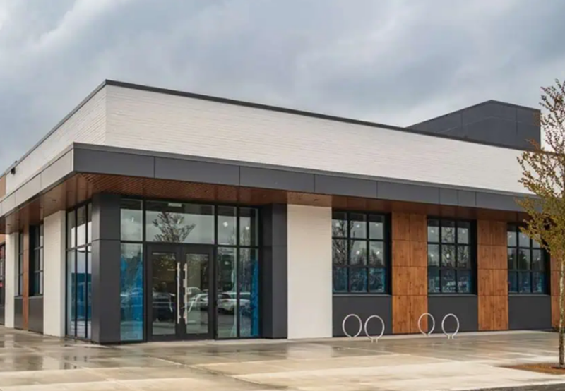 Completed commercial building with modern design and storefront windows