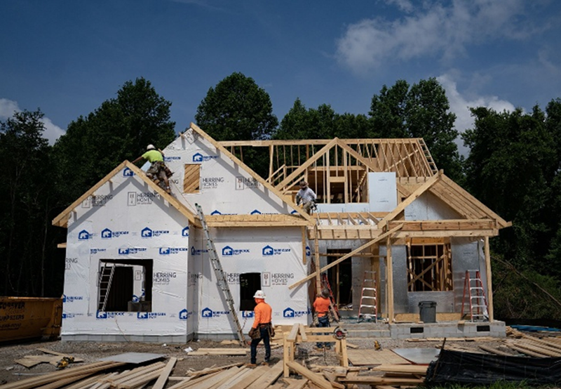 Stick-built house framing under construction with wooden structure